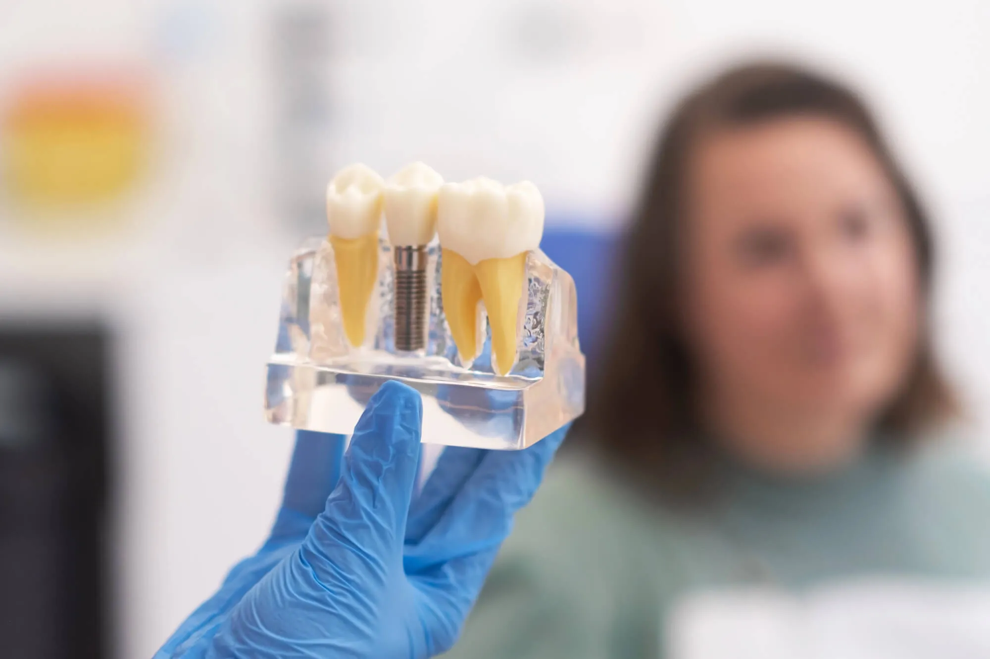 dentist explaining dental implants leesburg va to patient