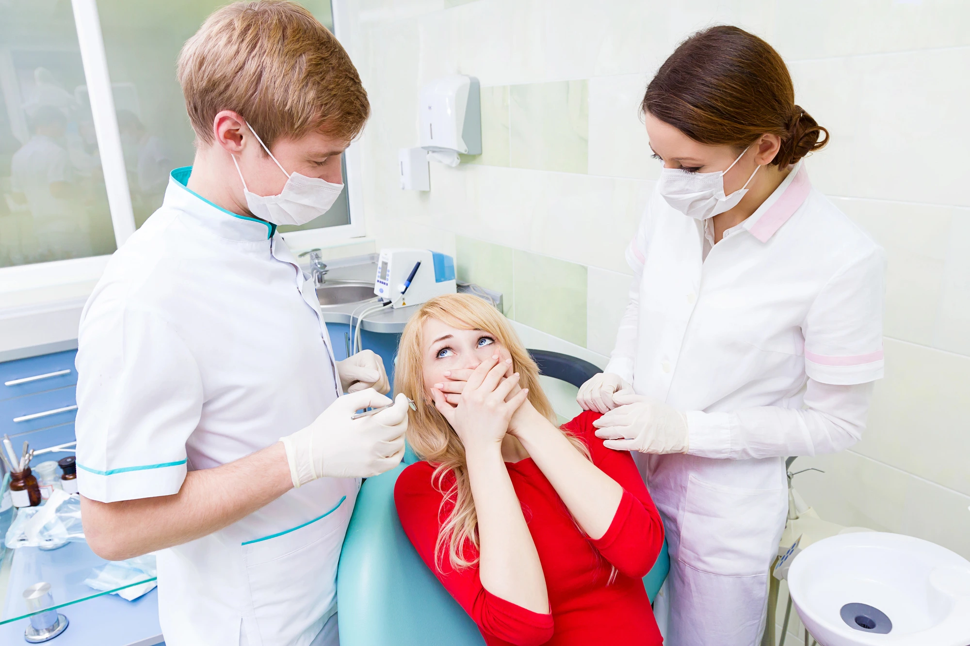 team comforting a patient experiencing anxiety due to a tooth extraction in Leesburg, VA