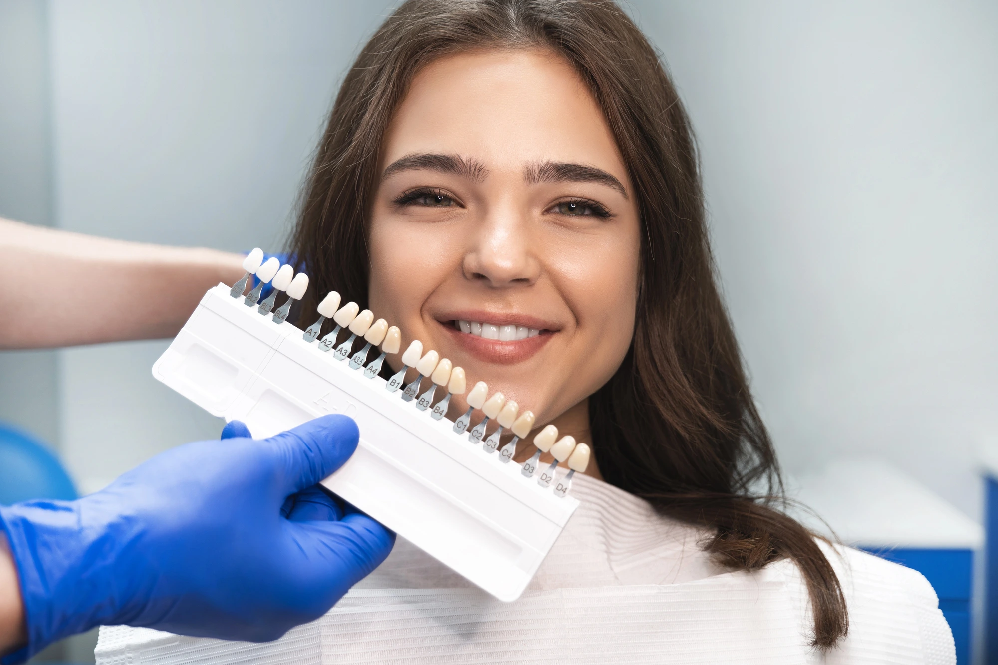 woman at the dentist comparing different veneers in Leesburg, VA