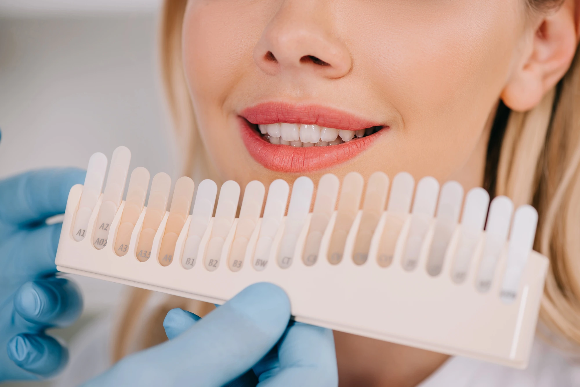 woman comparing teeth colors before teeth whitening in Leesburg, VA