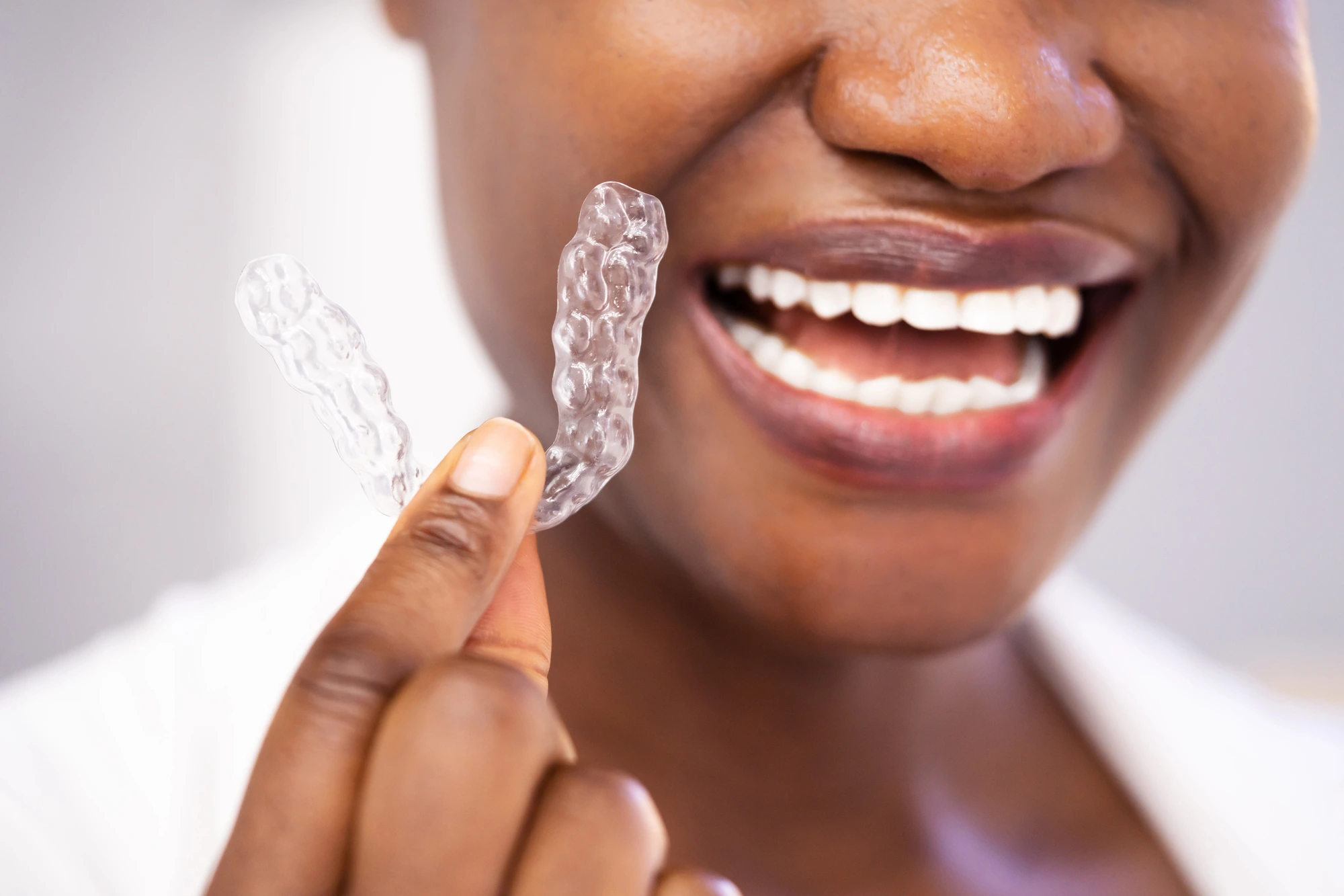 woman holding Invisalign in Leesburg, VA